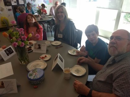 four people at a table talking